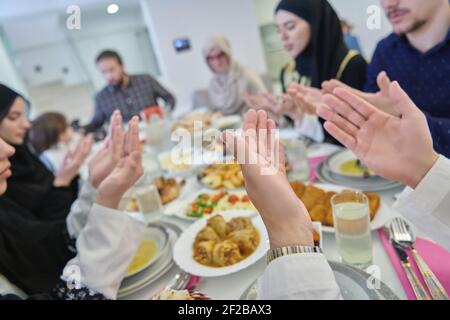 Muslimische Familie macht iftar dua Fasten während Ramadan zu brechen. Stockfoto