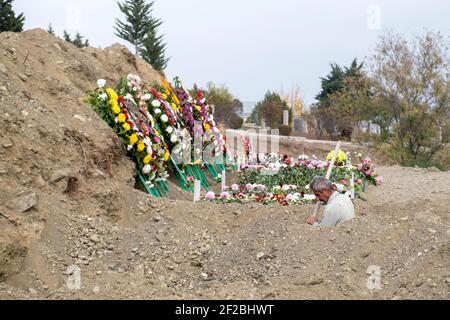 STEPANAKERT, BERG-KARABACH - NOVEMBER 05: Mann gräbt Gräber für armenische Militärangehörige, die bei Zusammenstößen mit aserbaidschanischen Truppen am 05. November 2020 in Stepanakert, Berg-Karabach, getötet wurden. Die Kämpfe zwischen Armenien und Aserbaidschan um Berg-Karabach in der selbsternannten Republik Arzakh, einem Teil der Republik Aserbaidschan, brachen Ende September in einen sechswöchigen Krieg mit beiden Ländern auf, die sich gegenseitig der Provokation beschuldigten, die Tausende Tote hinterließ. Stockfoto