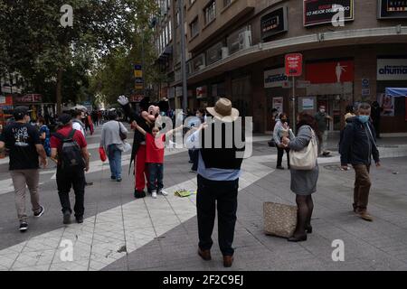 Santiago, Metropolitana, Chile. März 2021, 11th. Fußgänger fotografieren mit einer Mickey Mouse im Zentrum von Santiago. Quelle: Matias Basualdo/ZUMA Wire/Alamy Live News Stockfoto