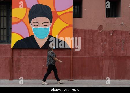 Santiago, Metropolitana, Chile. März 2021, 11th. Ein Fußgänger geht vor einem Gemälde, das zu Ehren des Gesundheitspersonals angefertigt wurde. Quelle: Matias Basualdo/ZUMA Wire/Alamy Live News Stockfoto