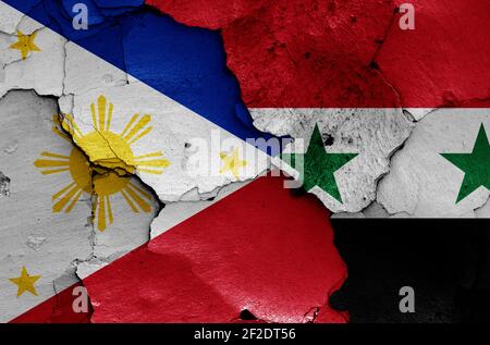 Flaggen von Philippinen und Syrien auf rissige Wand gemalt Stockfoto