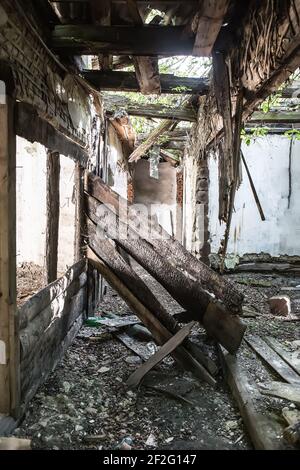 Das Innere eines alten zerstörten Holzhauses Stockfoto