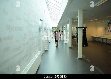 Ein Lehrer, der in einer Schule durch den Flur läuft Stockfoto