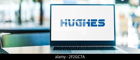 POZNAN, POL - 6. FEB 2021: Laptop-Computer mit Logo von Hughes Network Systems, einer hundertprozentigen Tochtergesellschaft von EchoStar Stockfoto