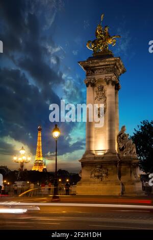 PARIS, Frankreich - 25. August 2016: Spalte auf Brücke Alexandre III und Eiffelturm bei Sonnenuntergang in Paris, Frankreich Stockfoto