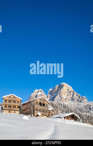 Traditionelle rustikale Holzhäuser im Dorf Coi im Val di Zoldo, verschneite Landschaft mit dem Monte Pelmo dahinter. Val di Zoldo, Provinz Belluno, Venetien, Italien Stockfoto