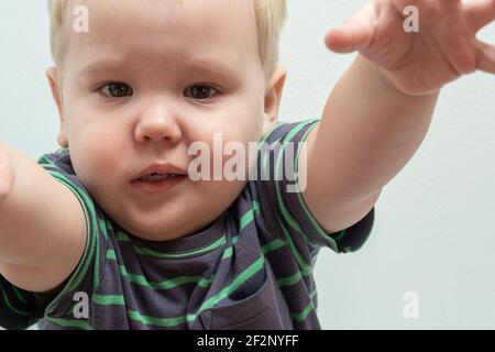 Niedliche Babys weinen und haben Spielzeug in ihren Händen. Stockfoto