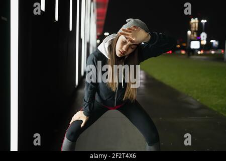 Die lächelnde während bereitet sich auf eine Nacht laufen um die Stadt Stockfoto