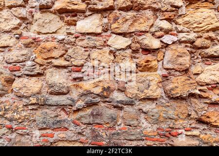 Textur der antiken Mauerwerk Wand. Textur einer Steinwand. (Mehrfarbige Steine) Stockfoto