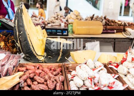 Neapel, Italien - 9. September 2019: Käse- und Wurstgeschäft auf einem Straßenmarkt mit Menschen in der Via Toledo, Neapel, Italien Stockfoto