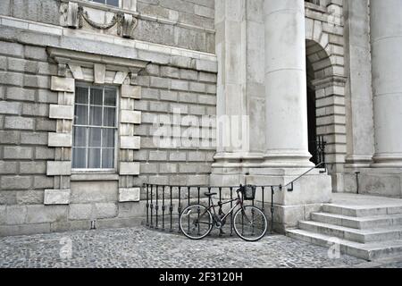 Fahrrad am Steineingang des Trinity College Campus in Dublin, Irland. Stockfoto