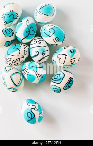 Kreative trendige bemalte ostereier auf weißem Hintergrund. Osterideen. Stockfoto