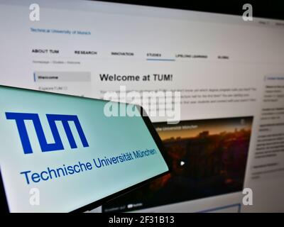 Mobiltelefon mit Logo der Technischen Universität München auf dem Bildschirm vor der Website. Fokus auf der Mitte des Telefondisplays. Stockfoto