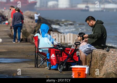 Eine hispanische Familie, die auf dem Deich entlang der Golfküste fischt. Houston, Texas, USA. Stockfoto