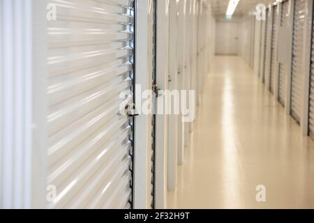 Nahsicht auf einen leeren Lagerflur mit einem gesicherten Vorhängeschloss Stockfoto