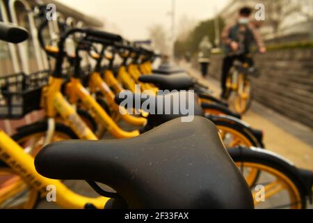 Peking, China. März 2021, 15th. Geteilte Fahrräder sind mit Staub bedeckt in Peking, Hauptstadt von China, 15. März 2021 gesehen. Schwimmender Staub traf Peking am Montag. Quelle: Li Xin/Xinhua/Alamy Live News Stockfoto