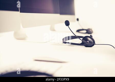 Microphone headsets on the table with computer keyboard, vintage tone effect Stock Photo