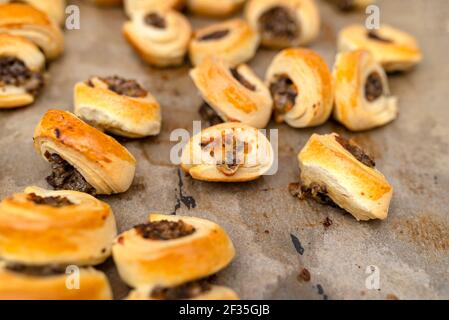 Frisch gebackene goldene Patties mit Pilzen auf Backpapier. Stockfoto