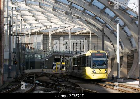 Victoria Station mit gelber Metrolink Straßenbahn auf dem Weg nach Piccadilly Verlassen der Station Stockfoto