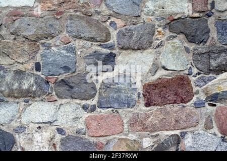 Gammelstad, Schweden, Schweden; EINE Wand aus großen, mehrfarbigen Steinen. Eine Wand aus großen, bunten Steinen. UN muro de grandes piedras de colores. Stockfoto