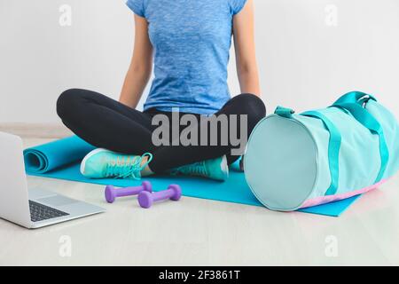 Junge Frau mit Sporttasche und Yogamatte im Fitnessstudio Stockfoto