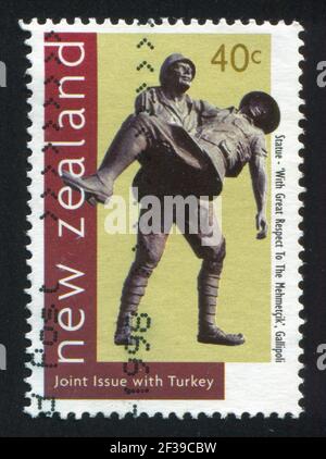 NEUSEELAND - UM 1998: Stempel gedruckt von Neuseeland, zeigt Statue mit türkischem Soldaten, der verwundeten Anzac trägt, um 1998 Stockfoto