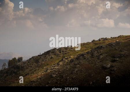 Berglandschaft aus Hochland und Wiesen mit Kontrast zu Schatten Der Wolken Stockfoto