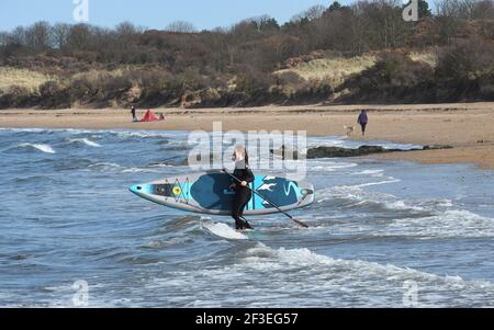 Gullane, East Lothian . Schottland Großbritannien 16th. März 21. Bei gutem Wetter trifft ein Stand Up Paddlebarder am Gullane Beach auf die Wellen. Kredit: eric mccowat/Alamy Live Nachrichten Stockfoto