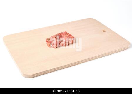 Roh hausgemachtes Schnitzel am Schneidebrett isoliert auf weiß Stockfoto