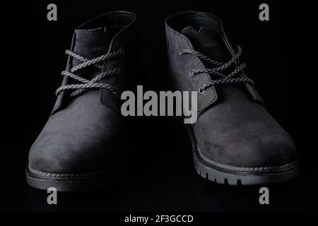 Schwarze Herren Wildlederschuhe auf schwarzem Hintergrund Stockfoto