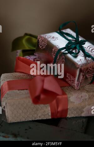 Weihnachtsgeschenke eingewickelt mit Schleifen und Metallic-Papier Stockfoto