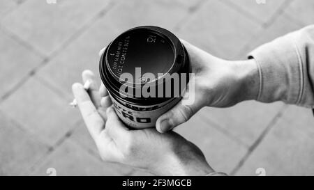 London, Großbritannien, März 17 2021, Nahaufnahme eines jungen Mannes, der eine Takeaway-Tasse von Cafe Nero Coffee hält Stockfoto