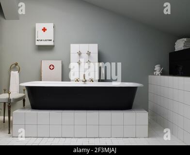 Freistehende Badewanne auf erhöhtem Sockel im Badezimmer in französischem Zuhause Stockfoto