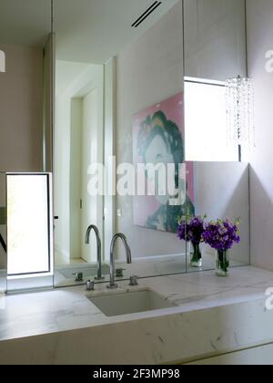 Mirror above washbasin in bathroom in Australian home Stock Photo