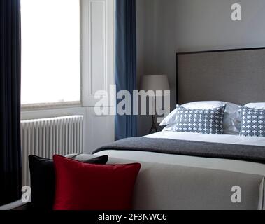 Eine offene Wohnung mit großen Fenstern mit Blick auf die Stadt. Moderne Möbel. Weiße Wände. Stockfoto
