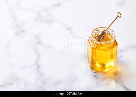 Oatmeal porridge with caramelized apples with cinnamon, banana, grated strawberries and honey on light marble background, top view. Stock Photo