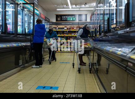 Carmarthenshire, Großbritannien. März 2021, 17th. Maskierte Menschen als vorbeugende Maßnahme gegen die Ausbreitung von covid-19 beim Einkaufen im Aldi Supermarkt in Wales, Großbritannien.Acht weitere Menschen sind in Wales an Coronavirus gestorben und die Infektionsrate ist insgesamt leicht gestiegen. Kredit: SOPA Images Limited/Alamy Live Nachrichten Stockfoto