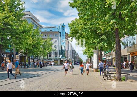 Mannheim, Deutschland - Juli 2019: Menschen, die an warmen Sommertagen mit Menschen und verschiedenen Geschäften durch die Innenstadt von Mannheim wandern Stockfoto