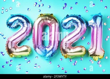 Bunte Folienballons machten Zahlen 2021 auf blauem Hintergrund mit hellen Bokehs. Frohes neues Jahr Feier Partei. Grüße und Gratulation Konzept Stockfoto