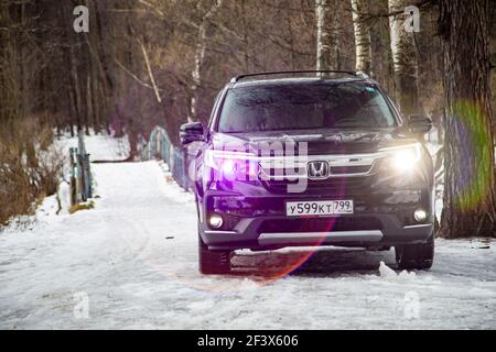 MOSKAU, RUSSLAND - 2. FEBRUAR 2020: Neuer Honda SUV Pilot 3 Generation Black im Winter Offroad. LED-Scheinwerfer-Optik schaltet die Vorderansicht ein Stockfoto