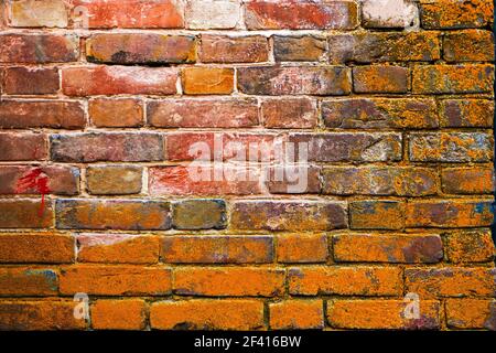 Verwitterte rote und braune gebeizte alte Backsteinmauer Hintergrund, Copyspace. Verwitterter roter und brauner verfärbter alter Backsteinwand-Hintergrund Stockfoto