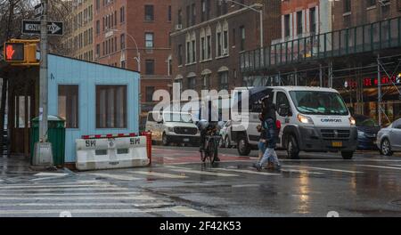 Lieferung Mann auf dem Fahrrad, Fußgänger am Crosswalk in New York City in Rain Stockfoto