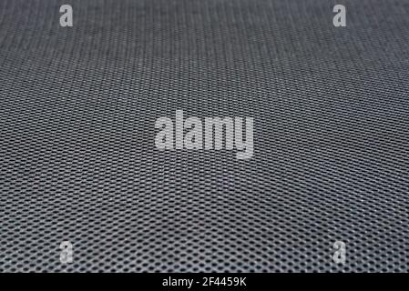 Schwarze synthetische Textil Möbel Polstergewebe. Hintergrund mit Löchern strukturiert Nahtloses Muster. Stockfoto