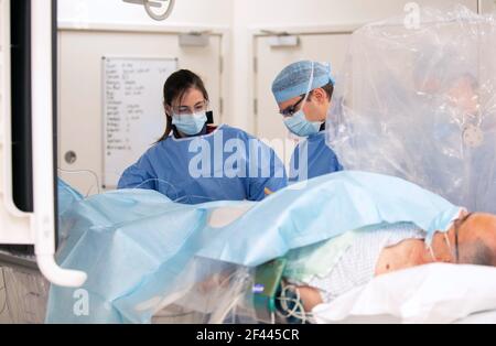 Kardiologen führen einen Eingriff an einem Patienten im Katheterlabor des Royal Papworth Hospital, Cambridge, durch. Bilddatum: Mittwoch, 17. März 2021. Stockfoto