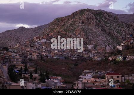 Akre, Irak. März 2021, 18th. Blick auf den Sonnenuntergang über der Altstadt von Akre.die Stadt Akre im Gouvernement Duhok bereitet sich darauf vor, Nowruz (das persische Neujahr oder das kurdische Neujahr) mit Fahnen über den Bergen zu feiern. Das persische Neujahr oder das Kurdische Neujahr ist eine alte zoroastrische Tradition, die von Iranern und Kurden am 20th. März jedes Jahres gefeiert wird und mit der Frühlingstaquinoktikum zusammenfällt. (Foto: Ismael Adnan/SOPA Images/Sipa USA) Quelle: SIPA USA/Alamy Live News Stockfoto