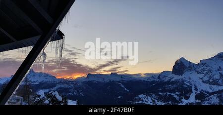 Die Sonne geht auf den Dolomiten mit den farbigen Wolken unter Stockfoto