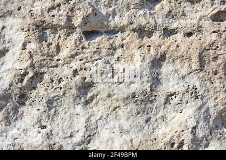 Eine Nahaufnahme einer strukturierten rauen Steinoberfläche Stockfoto