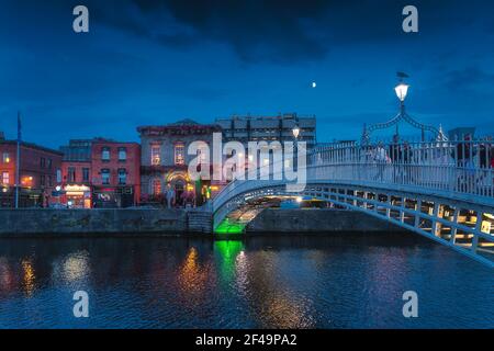 Dublin, Irland, August 2019 schöne Ha Penny Metal Fußgängerbrücke über Liffey River auf der Tempel Bar Straße bei Blue Hour, Nachtfotografie Stockfoto