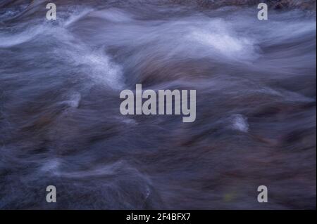 Wasser fließt über Felsen. Langzeitbelichtung. Abstrakter Hintergrund. Schönheit in der Natur. Stockfoto