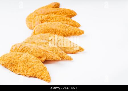 Schnelles Kochen.Paniertes Huhn Innenfilet auf einem weißen Hintergrund.Huhn paniertes rohes Fleisch. Stockfoto